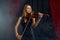 Female violonist with bow and violin, solo concert