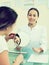 Female visitor consulting doctor in beauty clinic