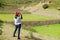 Female visitor taking photos of the ancient stepped agricultural terraces of Tipon, the Sacred valley of the Inca, Peru