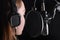 Female vocal recording. Young girl with microphone and headphones in recording studio. Recording of vocal, blogger, reading text,