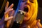 Female vocalist under gel lighting sings with passion into condenser microphone