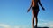 Female volleyball player standing on a rock in the beach 4k