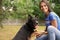 Female volunteer holding dog`s paw at animal shelter