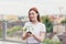 Female volunteer holds in her hands a seedling of a flower tree