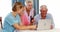 Female volunteer and senior citizens using laptop