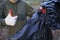 A female volunteer shows like and a black garbage bag, after clearing the forest of plastic. Environmental issues