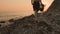 A female volunteer walks along the beach with a full bag of garbage and collects plastic bottles. Real time. The concept