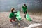 Female volunteers clean beach from garbage