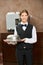 Female waiter in uniform with cloche