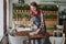 female waiter washes tables in restaurant or coffee shop, cleaning service in hotel kitchen.