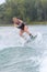 Female wakeboarder making tricks on lake