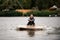 female wakeboarder start to rides on the water holding rope from motor boat