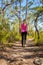 Female walking along a bush track among nature