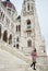 Female walking down steps of parliament at Budapest looked back