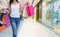 Female walks hands holding sale shopping bags in the mall