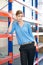 Female warehouse employee standing next to shelves