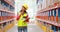 Female warehouse worker checking stock for shipping