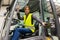 Female warehouse worker driving forklift. Warehouse worker preparing products for shipmennt, delivery, checking stock in