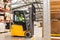 Female warehouse worker driving forklift. Warehouse worker preparing products for shipmennt, delivery, checking stock in