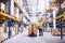 Female warehouse worker loading or unloading boxes.