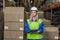 Female warehouse worker looking at camera