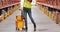 Female warehouse worker moping floor