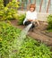 Female watering garden beds