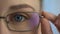 Female wearing eyeglasses and looking into camera, ophthalmic examination