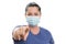 Female wearing medical or surgical mask pointing finger at screen