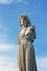 Female weathered statue in graveyard