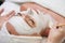 Female with white facial mask in spa treatment alternative medicine selective focus