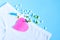 Female white panties with bow, birth control pills or vitamin, paper heart and positive pregnancy test on blue background. Health