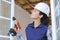 female window fitter holding cordless drill