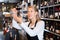 Female winemaker checking wine in store