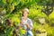 Female winemaker inviting to tasting wine in vineyard