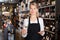 Female winemaker offering glass of wine for tasting