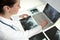 Female Woman Doctor Looking at X-Rays & Laptop