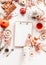 Female woman hand writes on blank white piece of paper on clipping board  on cozy autumn home desk with tea setting, cakes, autumn