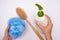 Female woman hands holding shower accessories, sponge and shower gel, body wash and a brush for scrubbing skin