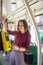 Female Woman paying conctactless with smartphone for the public transport in the tram.