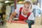 Female woodworker putting spirit level on plank