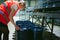 Female worker on beer factory. portrait woman in robe, standing on background line Food production, Inspection management control