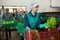 Female worker demonstrating ripe lettuce while sorting at a vegetable sorting factory