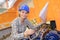 Female worker fixing boat enginee