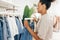 Female worker hangs jeans on a rack in a store