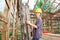 Female Worker Holding Ladder In Wooden Cabin At