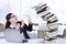 Female worker holds a pile of falling books