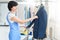 Female worker in Laundry service the process of working on universal automatic equipment for steaming, Ironing and cleaning