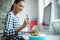 Female Worker In Office Having Healthy Chicken Salad Lunch At Desk