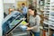 Female worker packs notebooks in a vacuum packing